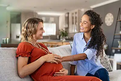 Pregnant woman meeting adoptive mom in our Christian mission statement for adoption
